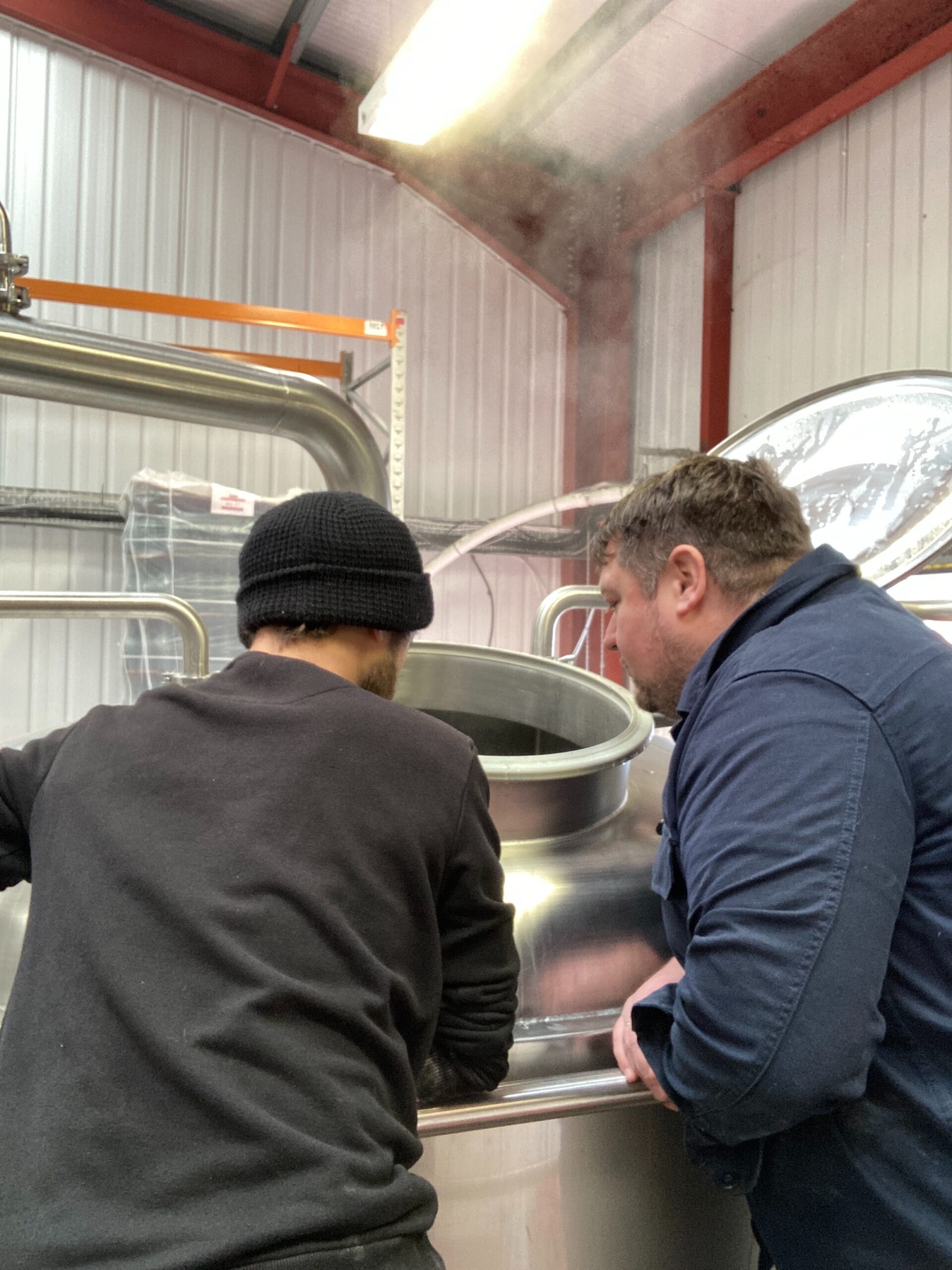 Inspecting the collab beer brew at RedWillow brewery