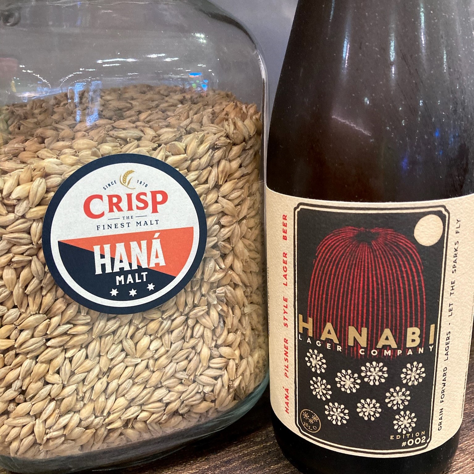 A. bag of heritage two-row barley grains, Hana malt and a bottle of Hanabi beer.